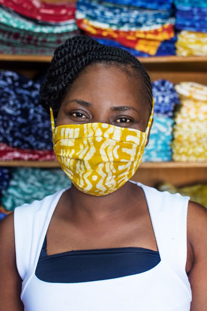 Priscilla wearing a yellow patterned face mask