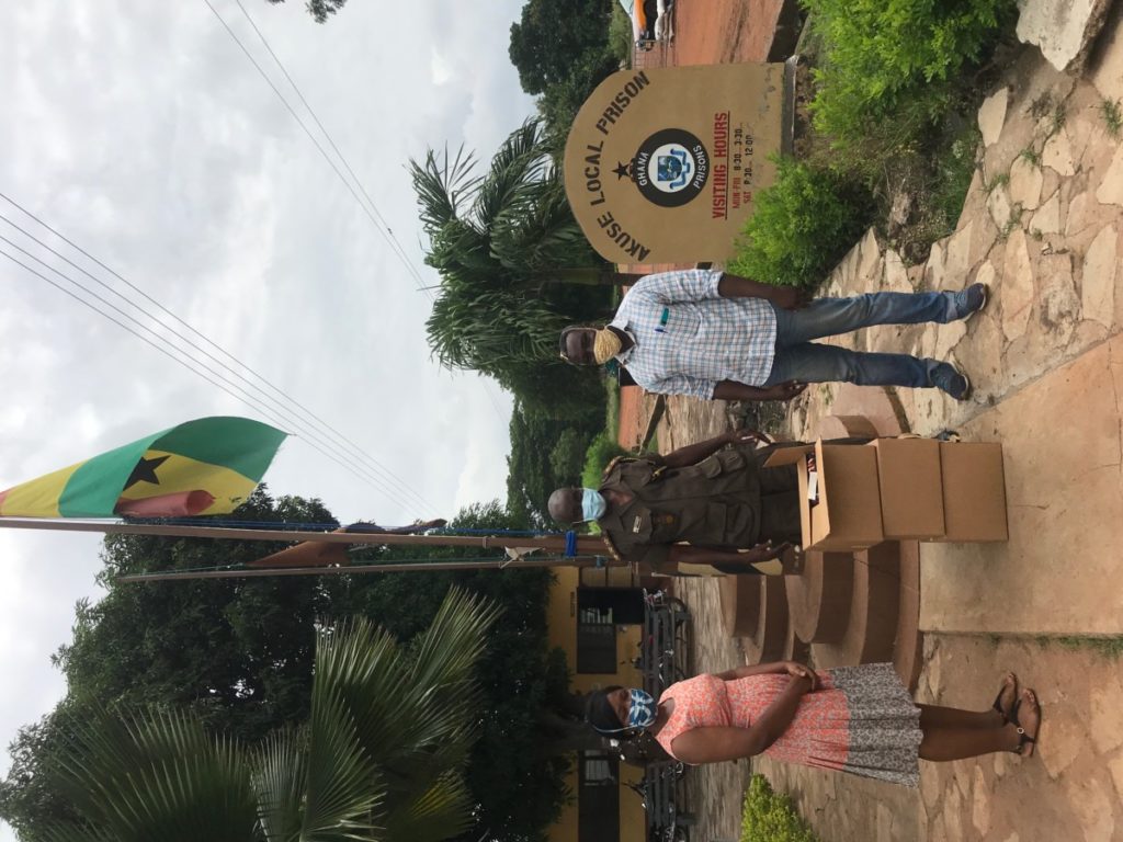 Elizabeth Adams and Amos Kporshiebu delivering boxes of face masks to Akuse Local Prison.