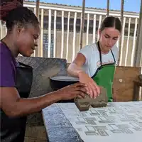 Batiking Workshop at Global Mamas stamping wax on fabric with foam