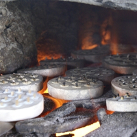 Global Mamas Bead Making Workshop near the Global Mamas Fair Trade Zone firing the recycled glass beads in a kiln