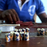 Global Mamas Beading Workshop assembling a fair trade bracelet