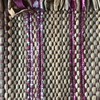 Weaving Workshop at Global Mamas with finished woven fabric using water hyacinth and thread 