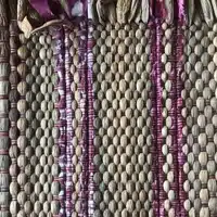 Weaving Workshop at Global Mamas with finished woven fabric using water hyacinth and thread